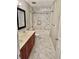 Bathroom with a double vanity, modern fixtures, and marble-patterned shower and flooring at 121 Brittany Ct, Duluth, GA 30096