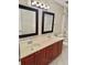Double vanity bathroom with modern fixtures, ample counter space, and marble-patterned shower in the background at 121 Brittany Ct, Duluth, GA 30096