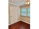 Bedroom with neutral walls, hardwood flooring, door and two windows at 121 Brittany Ct, Duluth, GA 30096