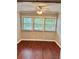 Bright bedroom featuring hardwood flooring, ceiling fan, and natural light at 121 Brittany Ct, Duluth, GA 30096