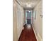 Hallway featuring hardwood flooring, closet and modern light fixture at 121 Brittany Ct, Duluth, GA 30096