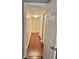 Hallway with hardwood floors, a white door, and natural light filtering through to additional rooms at 121 Brittany Ct, Duluth, GA 30096