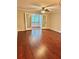 Living room featuring hardwood floors, ceiling fan, and glass doors to enclosed patio at 121 Brittany Ct, Duluth, GA 30096