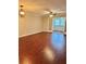 Living room featuring hardwood floors, ceiling fan, and glass doors to enclosed patio at 121 Brittany Ct, Duluth, GA 30096