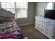 bedroom with a window, a bed, and dresser with a mirror and TV at 1504 Gallup Dr, Stockbridge, GA 30281