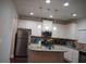 Bright kitchen featuring an island, stainless steel appliances, granite countertops, and white cabinetry at 1504 Gallup Dr, Stockbridge, GA 30281