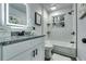 Bright bathroom features a shower over tub, granite counters, and illuminated mirror at 2162 Westover Dr, Atlanta, GA 30344