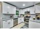 Updated kitchen with white cabinets, stainless steel appliances, and granite countertops at 2162 Westover Dr, Atlanta, GA 30344
