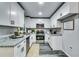Bright kitchen featuring white cabinets, granite countertops, and modern stainless steel appliances at 2162 Westover Dr, Atlanta, GA 30344
