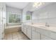 Light and airy bathroom featuring a tub, double vanity and natural light at 2701 Log Cabin Se Dr, Atlanta, GA 30339
