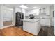 Bright kitchen featuring white cabinetry, granite countertops, and an island at 2701 Log Cabin Se Dr, Atlanta, GA 30339