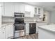 Bright kitchen features stainless steel appliances, granite countertops, and white cabinets at 2701 Log Cabin Se Dr, Atlanta, GA 30339