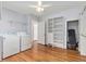Functional laundry area with washer, dryer, shelving, and closet space at 2701 Log Cabin Se Dr, Atlanta, GA 30339