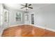 Bright living room featuring hardwood floors, built-in shelving, and a ceiling fan at 2701 Log Cabin Se Dr, Atlanta, GA 30339