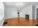 Spacious living room with hardwood flooring, a fireplace, and modern lighting at 2701 Log Cabin Se Dr, Atlanta, GA 30339