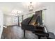 Spacious living room features grand piano, wood floors, and updated lighting fixtures at 2701 Log Cabin Se Dr, Atlanta, GA 30339