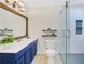 Stylish bathroom with a glass-enclosed shower, modern vanity, and decorative mirror at 4870 Twin Lakes Trail, Atlanta, GA 30360