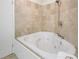 Bathroom featuring large soaking tub with tile surround at 4870 Twin Lakes Trail, Atlanta, GA 30360