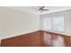Bedroom with neutral walls, wood flooring, ceiling fan, and double windows at 4870 Twin Lakes Trail, Atlanta, GA 30360