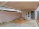 Attached covered carport featuring neutral siding and adjacent exterior storage, with two entry doors nearby at 4870 Twin Lakes Trail, Atlanta, GA 30360