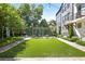 Sprawling backyard with lush artificial turf, cozy pergola lounge area, and manicured landscape at 126 Chestnut Cir, Atlanta, GA 30342