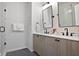 Bathroom boasts double sinks, modern fixtures, wood cabinets, and a glass enclosed shower at 126 Chestnut Cir, Atlanta, GA 30342