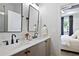 Bright bathroom features a double vanity with modern fixtures, and a view into a bedroom at 126 Chestnut Cir, Atlanta, GA 30342