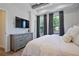 Well-lit bedroom with a tray ceiling, grey dresser and windows covered with dark curtains at 126 Chestnut Cir, Atlanta, GA 30342