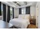 Serene bedroom with tray ceiling, wood beam accents, large windows, and natural light at 126 Chestnut Cir, Atlanta, GA 30342