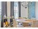Well-lit dining room with stylish furniture, a bar cart, and distinctive decor against a backdrop of large windows at 126 Chestnut Cir, Atlanta, GA 30342