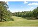 View of lush green golf course with mature trees and manicured fairway with scenic views at 126 Chestnut Cir, Atlanta, GA 30342