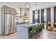 Contemporary kitchen with stainless steel refrigerator, spacious island with bar seating, and modern light fixtures at 126 Chestnut Cir, Atlanta, GA 30342
