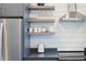 Bright kitchen featuring floating shelves, stainless appliances, and white shiplap wall at 126 Chestnut Cir, Atlanta, GA 30342