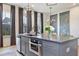Modern kitchen featuring an island with integrated appliances, stylish pendant lighting, and adjacent dining area at 126 Chestnut Cir, Atlanta, GA 30342
