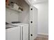 Clean laundry room featuring a modern washer and dryer, as well as overhead shelving at 126 Chestnut Cir, Atlanta, GA 30342
