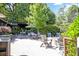 Outdoor lounge and dining patio with modern furniture, manicured landscaping, and cafe lighting at 126 Chestnut Cir, Atlanta, GA 30342