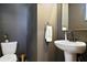 Chic powder room features a pedestal sink, modern faucet, and stylish decor at 126 Chestnut Cir, Atlanta, GA 30342