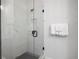 Modern shower with glass door and marble-look tile, featuring black fixtures and a shower niche at 126 Chestnut Cir, Atlanta, GA 30342