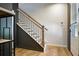 Elegant staircase with wooden banister and black metal spindles, showcasing modern design at 126 Chestnut Cir, Atlanta, GA 30342