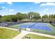 Outdoor tennis courts with shade trees, walkways, and well-maintained blue and green playing surfaces at 126 Chestnut Cir, Atlanta, GA 30342