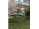 Charming home with manicured lawn, flowering trees, and a lovely teal front door at 136 Bucher Dr, Decatur, GA 30030