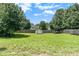 A large backyard featuring a shed, trampoline and full wood privacy fence at 1478 Elena Dr, Mcdonough, GA 30253