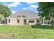Backyard featuring a grassy lawn and an elevation of the home showing a patio and lots of natural light at 1478 Elena Dr, Mcdonough, GA 30253