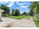 Well-manicured backyard with concrete patio and view of surrounding greenery and wooden fence at 1478 Elena Dr, Mcdonough, GA 30253
