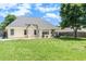 Backyard featuring a grassy lawn and an elevation of the home showing a patio and lots of natural light at 1478 Elena Dr, Mcdonough, GA 30253