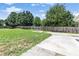 Large backyard with grassy lawn, concrete patio, surrounded by a wood privacy fence at 1478 Elena Dr, Mcdonough, GA 30253