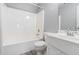 Bathroom with white shower-tub combo, toilet, and vanity with sink and mirror at 1478 Elena Dr, Mcdonough, GA 30253