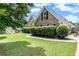 Brick home boasts lush landscaping, and a well-manicured lawn and charming curb appeal at 1478 Elena Dr, Mcdonough, GA 30253