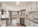 Kitchen view showcasing white cabinetry, wood counters, and stainless steel appliances at 1478 Elena Dr, Mcdonough, GA 30253