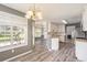 Bright kitchen leading to a dining area with wood floors and backyard view at 1478 Elena Dr, Mcdonough, GA 30253